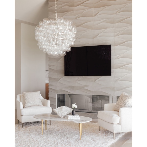 Living room mantle with two white chairs and glass chandelier